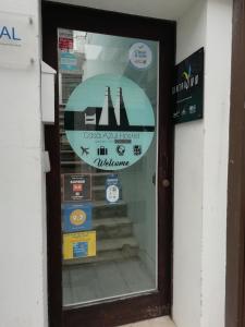 a window of a store with a sign on it at Casa Azul Hostel in Sintra