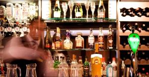 a bar filled with lots of bottles of alcohol at The Tudor Hotel in Harrow
