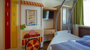 a childs room with a toy house and a table at Pension Haus Sanz in Vienna