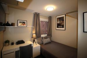 a small room with a bed and a window at Kongensgate Apartments in Kristiansand