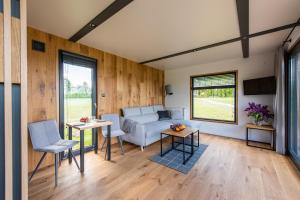 a living room with a couch and a table at Pałac Warlity in Olsztynek