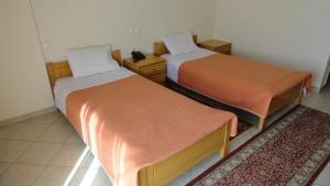 A bed or beds in a room at Hotel Kastro
