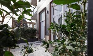 a door to a house with plants in front of it at Le bougainvillea 2 in Corbetta