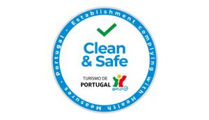 a blue clean and safe logo with a green arrow in the middle at Stylish Lisbon Apartment in Alfama in Lisbon