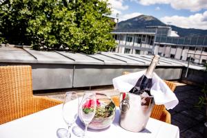 a bottle of wine sitting on a table with glasses at Apartment-Hotel Schaffenrath in Salzburg