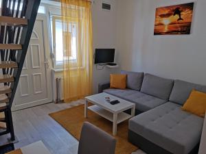a living room with a couch and a table at RIS CENTRAL Apartments in Novi Sad