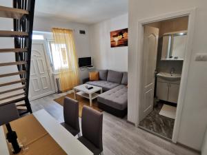 a living room with a couch and a table at RIS CENTRAL Apartments in Novi Sad +28 photos