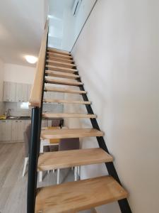 a staircase with wooden steps in a room at RIS CENTRAL Apartments in Novi Sad +18 photos