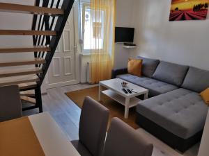 a living room with a couch and a table at RIS CENTRAL Apartments in Novi Sad