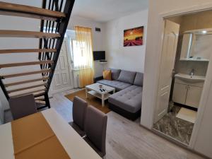 a living room with a couch and a table at RIS CENTRAL Apartments in Novi Sad