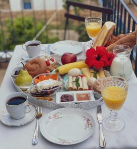 a table with a tray of breakfast foods and drinks at Katrina's apartments in Skala Kefalonias