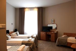 Postel nebo postele na pokoji v ubytování Hotel Jan Sander