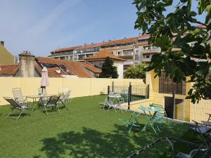 a group of chairs and tables on a lawn at Urban Suites in Aveiro