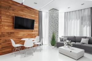 a living room with a couch and a table and chairs at Feeria Apartment in Odesa