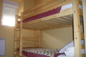 a bedroom with two bunk beds in a room at LA TRUFFIERE in Castelnau-de-Mandailles
