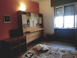 a room with a bed and a dresser and a window at Hotel La Torre in Cogoleto