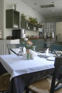 a table with a white table cloth on it in a kitchen at Ilis Hotel in Olympia