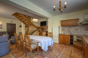 a kitchen and dining room with a table and a staircase at Dom Myśliwski in Szklarska Poręba