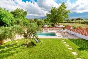 an image of a backyard with a pool and trees at Villa Archontiki I - Private Pool in Vryses