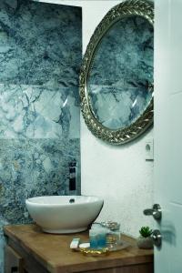 a bathroom with a sink and a mirror on the wall at Taksim Yazıcı Residence in Istanbul