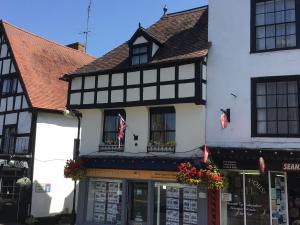 a black and white building with a store at Stylish 3 bedroom apartment in Upton upon Severn