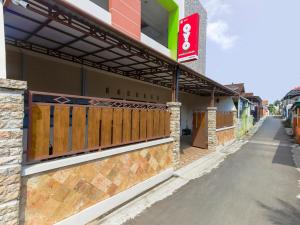 a building with a gate on the side of a street at Super OYO 3314 Syariah House in Purwokerto