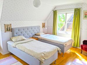 a bedroom with two beds and a window at Fiskargränd 5 in Visby +70 photos