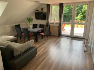 a living room with a table and a couch at Borsi Apartman in Balatonalmádi