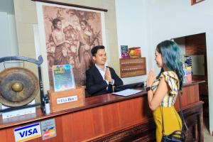 a woman talking to a man at a cash register at Saravoan Royal Palace in Phnom Penh