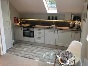 a kitchen with a counter and a sink and a table at Frogmill Studio in Exeter