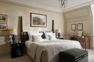 a bedroom with a large bed and a desk at The Gleneagles Hotel in Auchterarder