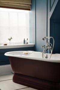 a bath tub in a bathroom with a window at The Gleneagles Hotel in Auchterarder