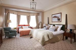 a large bedroom with a large bed and a chair at The Gleneagles Hotel in Auchterarder