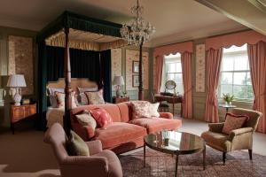 a bedroom with a bed and a couch and a table at The Gleneagles Hotel in Auchterarder