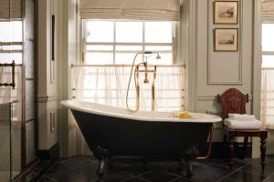 a bath tub in a bathroom with a window at The Gleneagles Hotel in Auchterarder