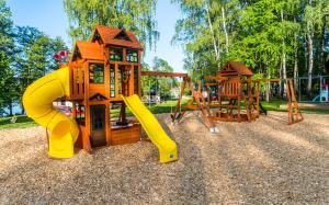 a playground with a slide and a slideintend at Obora resort in Lanškroun