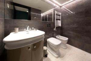 a bathroom with a sink and a toilet and a mirror at Residence Poli Venezia in Venice