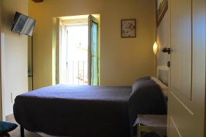 Postel nebo postele na pokoji v ubytování Alter Ego b&b Assisi
