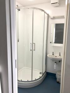 a bathroom with a shower and a sink at FSC Millport Hostel in Millport