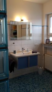 a bathroom with a sink and a mirror at Ferienwohnung Hagelstein in Bad Mergentheim