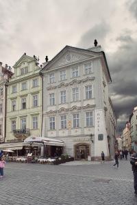 a large white building with people walking in front of it at Old Town Square Residence by Emblem in Prague