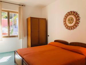 a bedroom with a bed and a mirror on the wall at Ponza Cala Feola IMMOBILEVANTE in Ponza