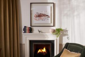 a fireplace with a fire in a living room at The Gleneagles Hotel in Auchterarder