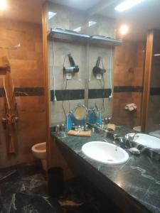 a bathroom with a sink and a toilet at Hotel Kerala in San Esteban de Pravia