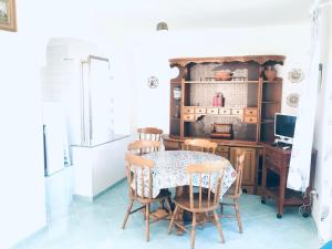 a dining room with a table and chairs and a desk at Ponza Cala Feola IMMOBILEVANTE in Ponza