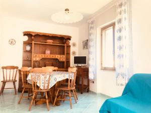 a dining room with a table and a desk at Ponza Cala Feola IMMOBILEVANTE in Ponza