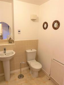 a bathroom with a toilet and a sink at Firpark City Apartment - 2 Bedrooms in Glasgow