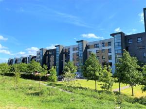 an apartment building with a park in front of it at Firpark City Apartment - 2 Bedrooms in Glasgow