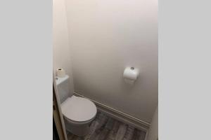 a bathroom with a toilet and a roll of toilet paper at La Fayette 2*, Meublé tout confort avec vue sur le port in Rochefort