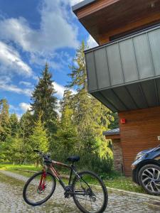 a bike parked in front of a house at Borovets Chalets in Borovets